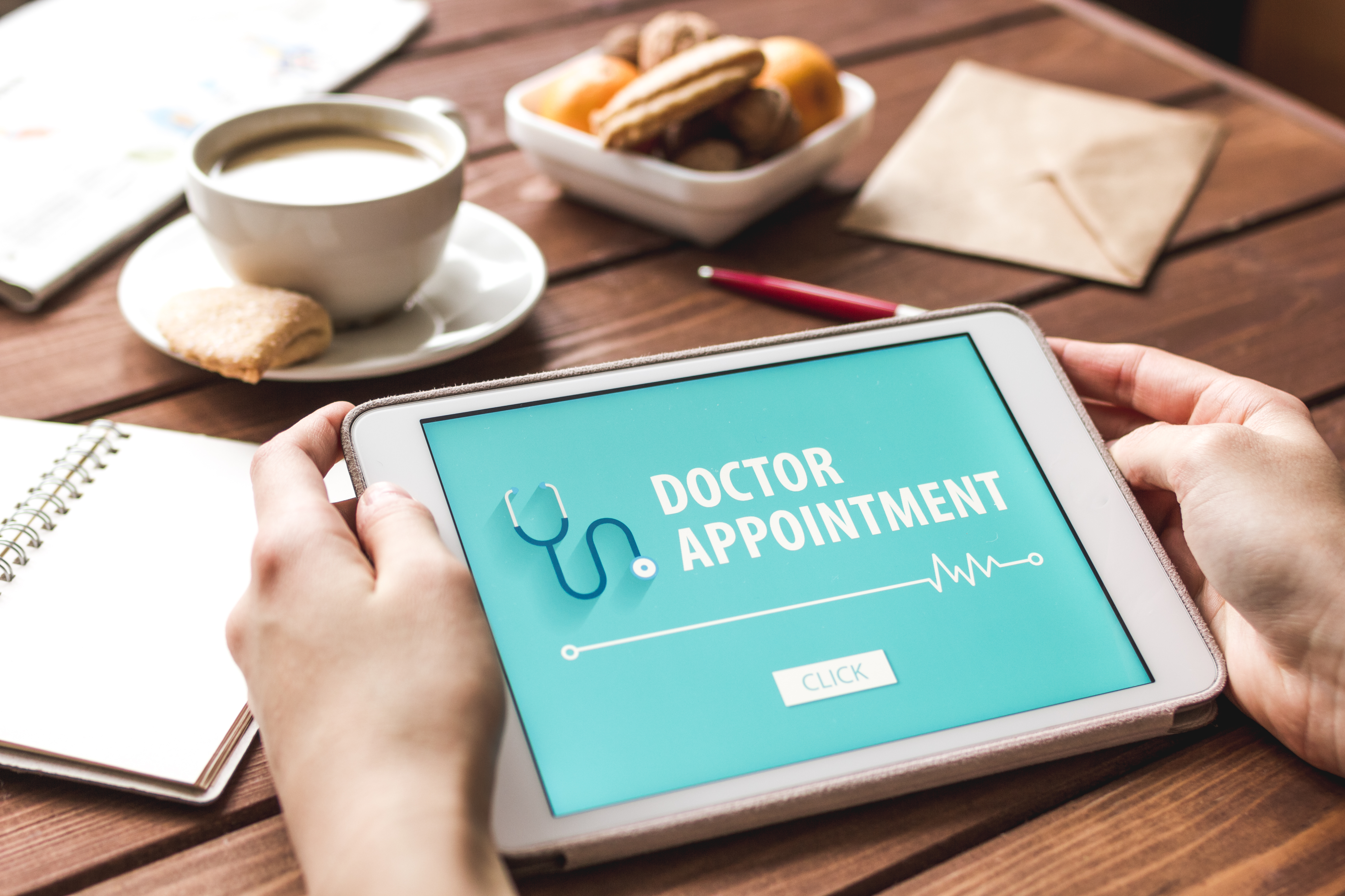 Patient holding tablet with Doctor Appointment app