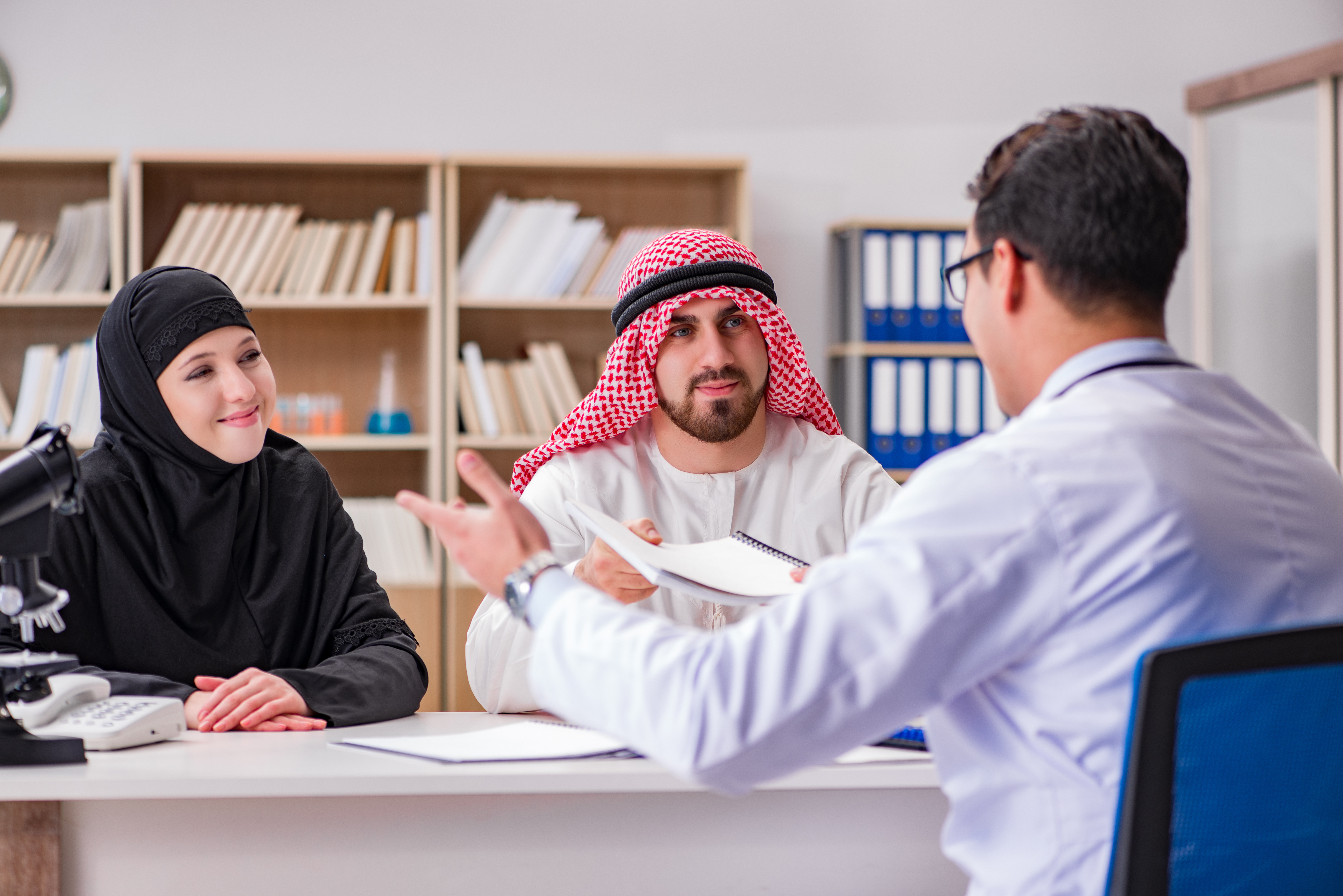 Arab couple consulting doctor